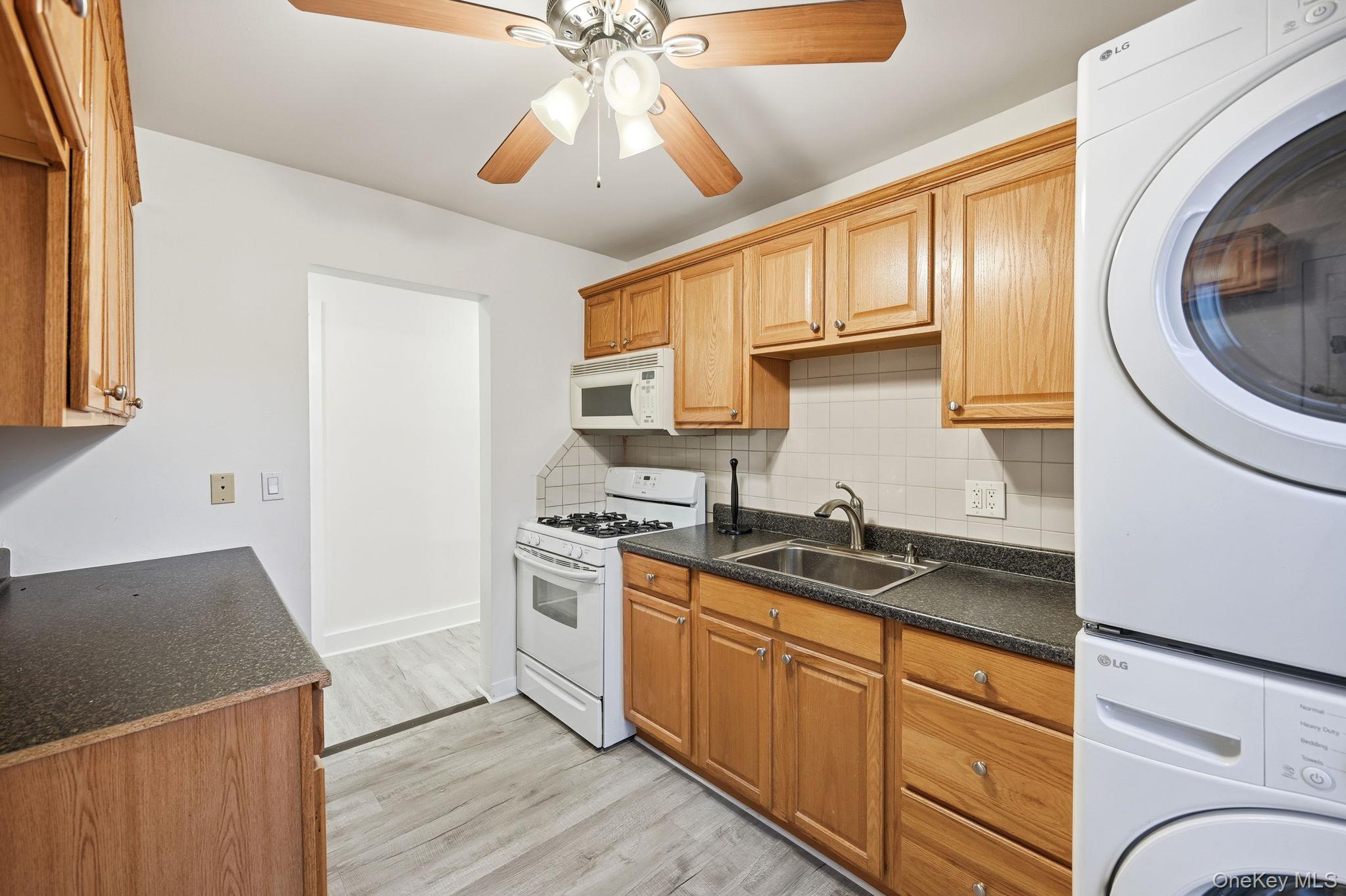 359 Orangeburg Road, Unit 2 Pearl River, NY 10965 - Photo 13 of 39 a kitchen with stainless steel appliances granite countertop a sink a stove a refrigerator cabinets and wooden floor