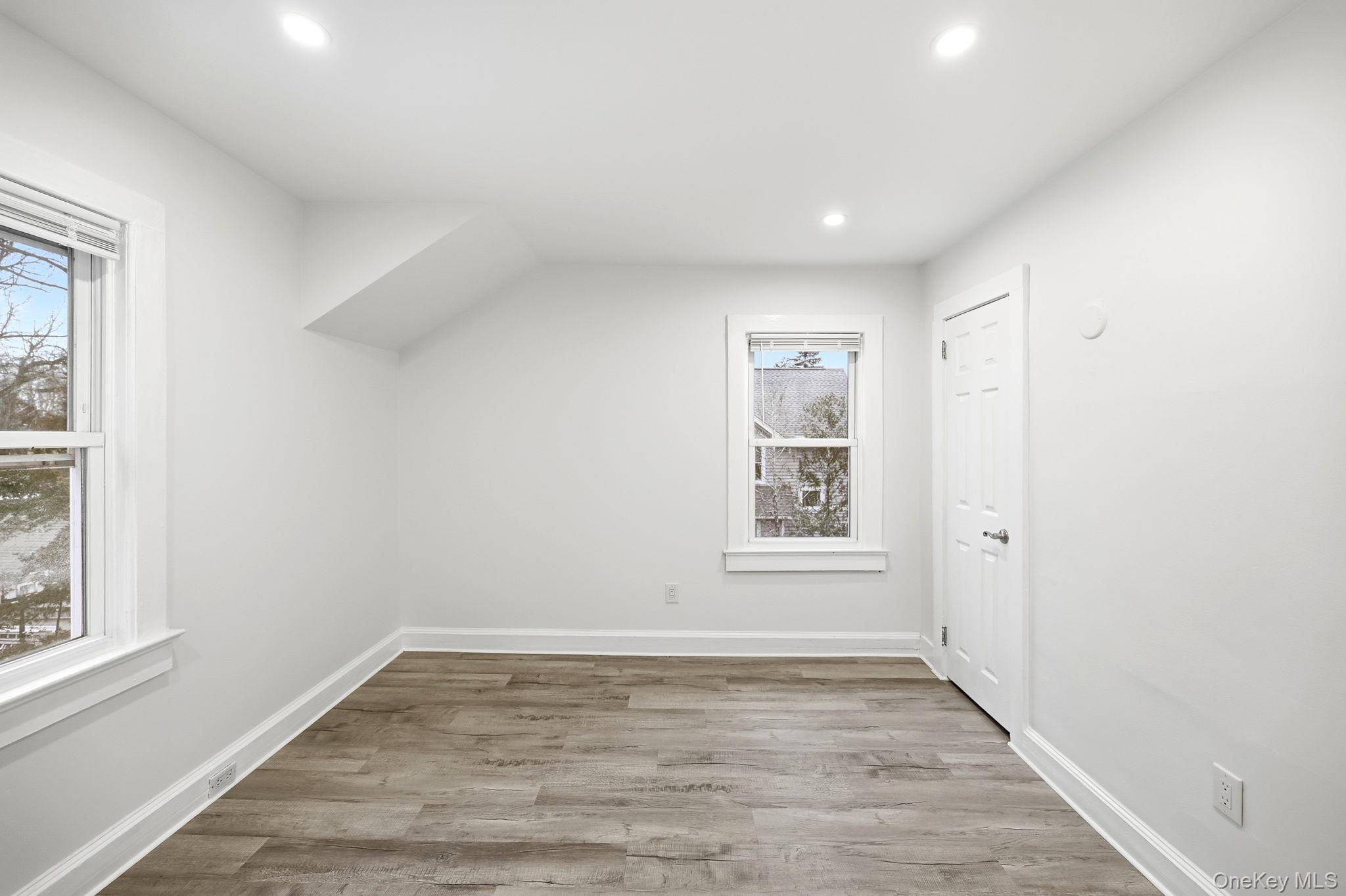 359 Orangeburg Road, Unit 2 Pearl River, NY 10965 - Photo 19 of 39 a view of an empty room with wooden floor and a window