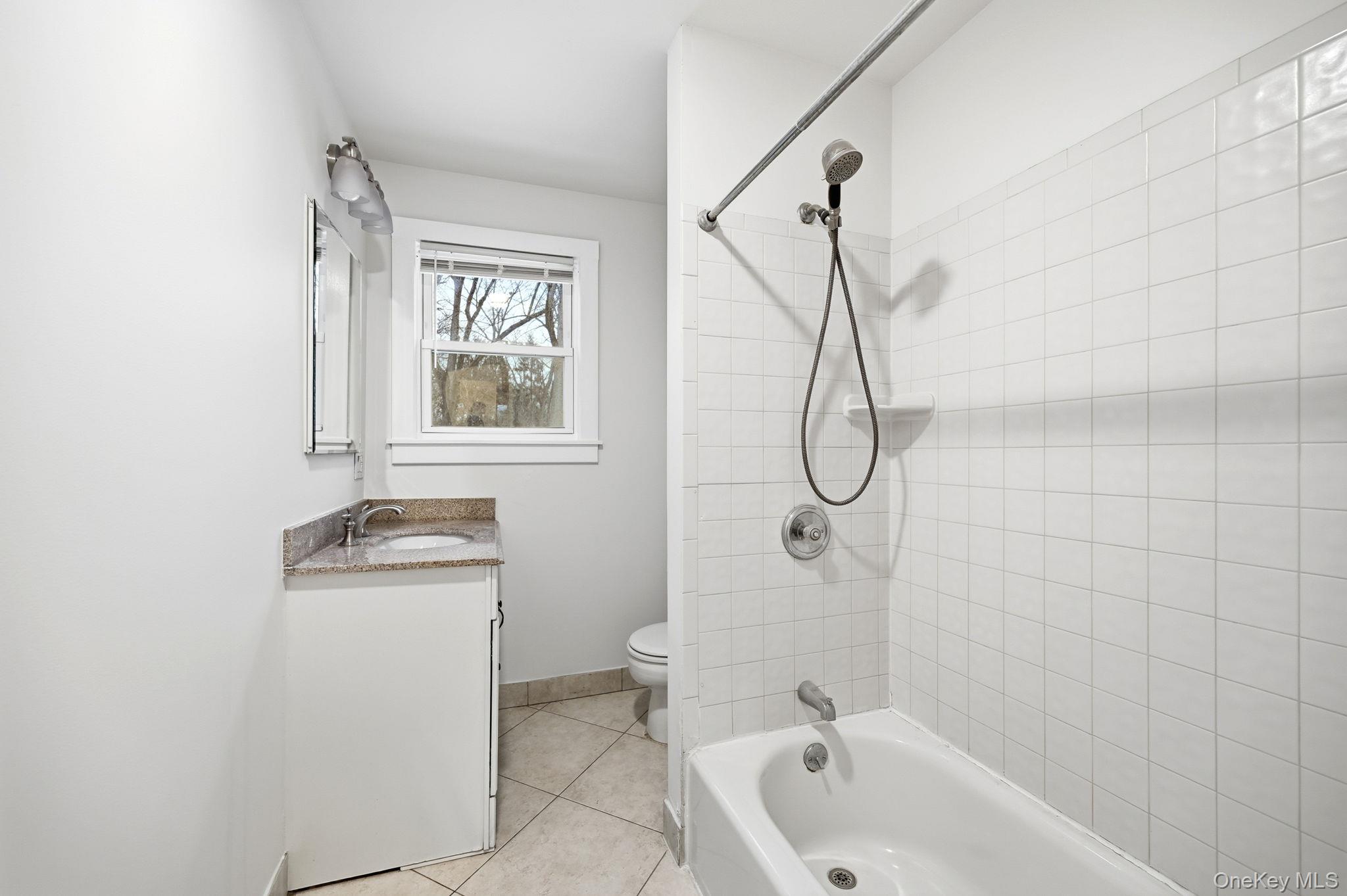 359 Orangeburg Road, Unit 2 Pearl River, NY 10965 - Photo 22 of 39 a bathroom with a granite countertop sink a toilet and shower