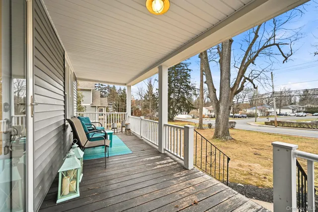 a view of a chair and tables in the balcony