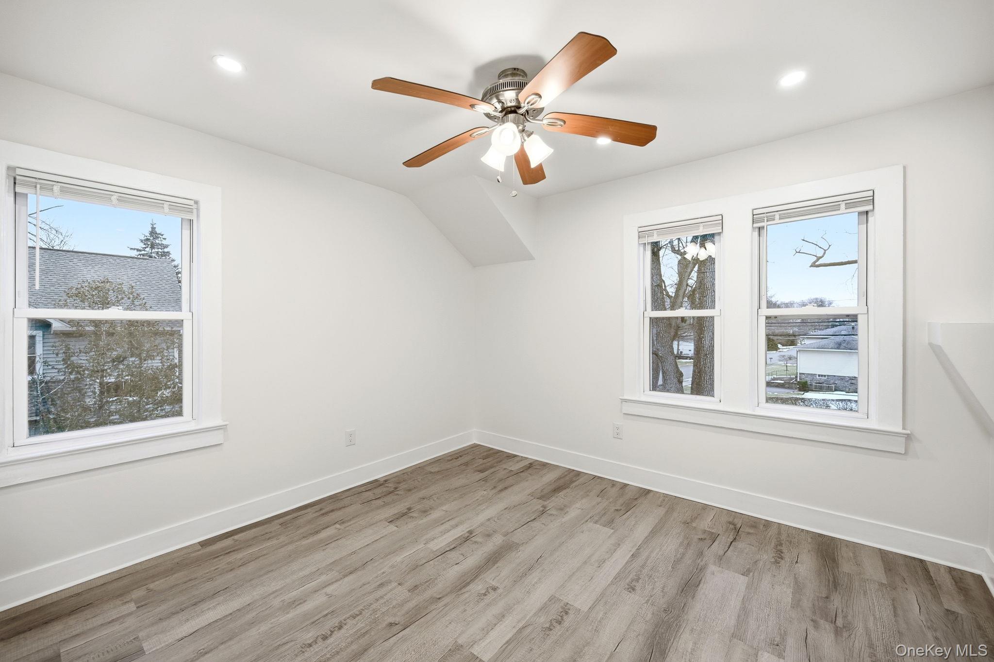 359 Orangeburg Road, Unit 2 Pearl River, NY 10965 - Photo 31 of 39 a view of an empty room with wooden floor and a window