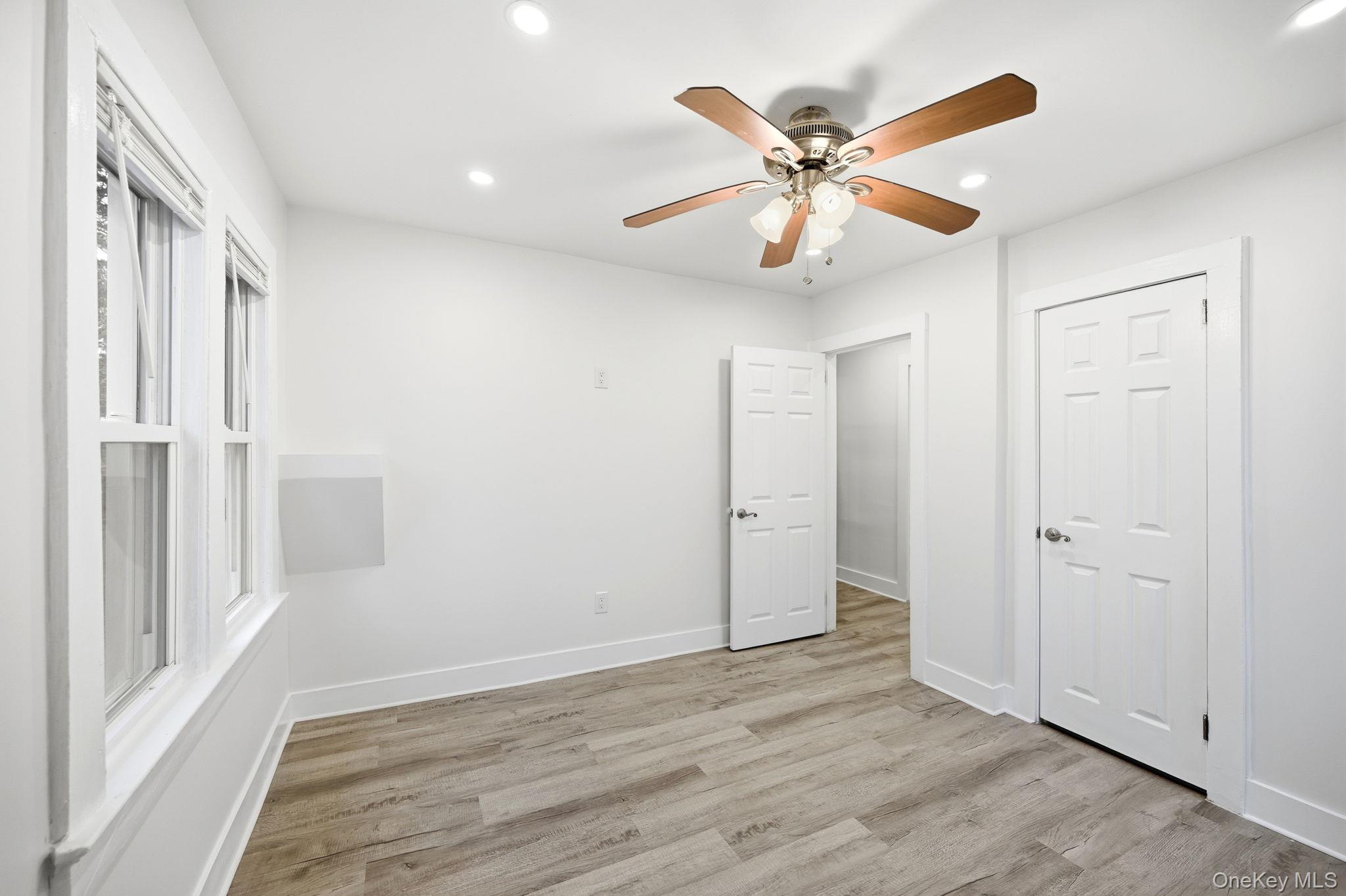 359 Orangeburg Road, Unit 2 Pearl River, NY 10965 - Photo 33 of 39 a view of an empty room with wooden floor and a ceiling fan