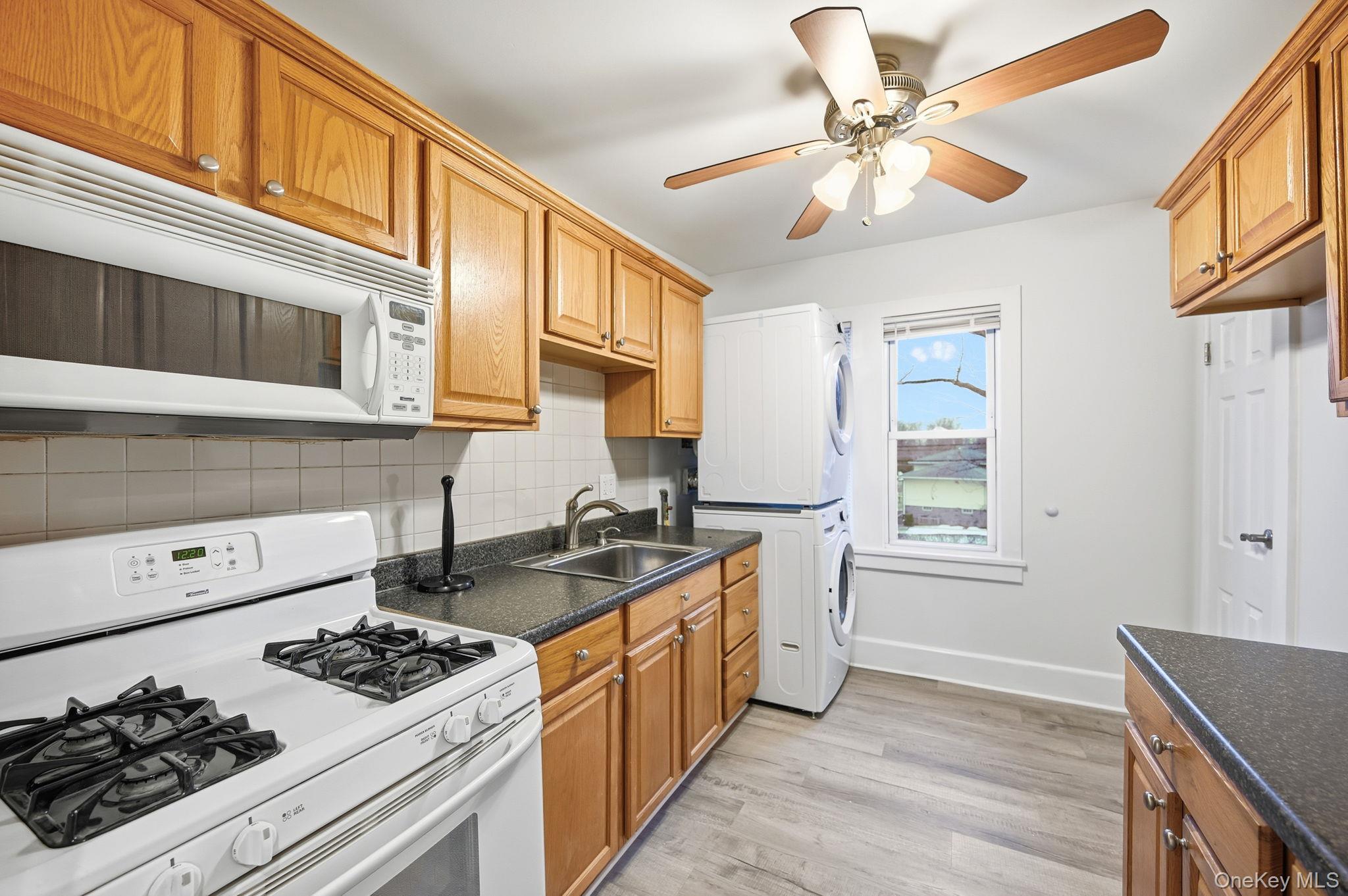 359 Orangeburg Road, Unit 2 Pearl River, NY 10965 - Photo 10 of 39 a kitchen with a stove a sink and a microwave