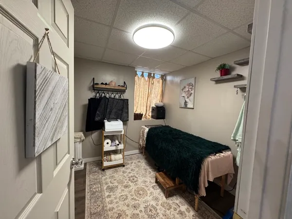 a bedroom with a bed and a mirror