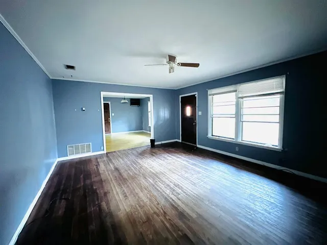 a view of a livingroom with a ceiling fan and window
