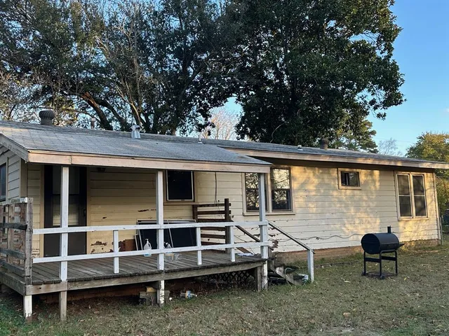 a view of a house with a yard and sitting area
