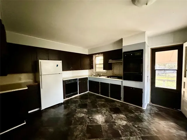 a kitchen with a refrigerator and a sink