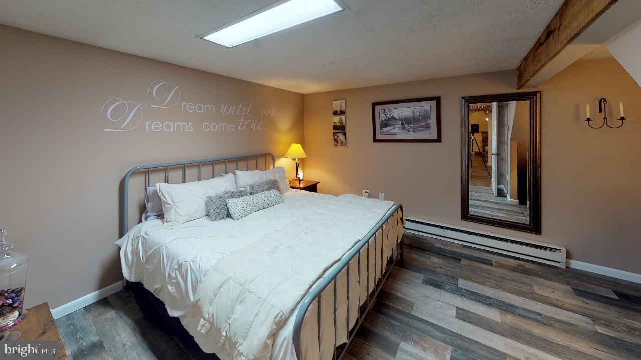 793 Mountain View Road Reading, PA 19607 - Photo 12 of 21 a bedroom with bed and paintings on the wall