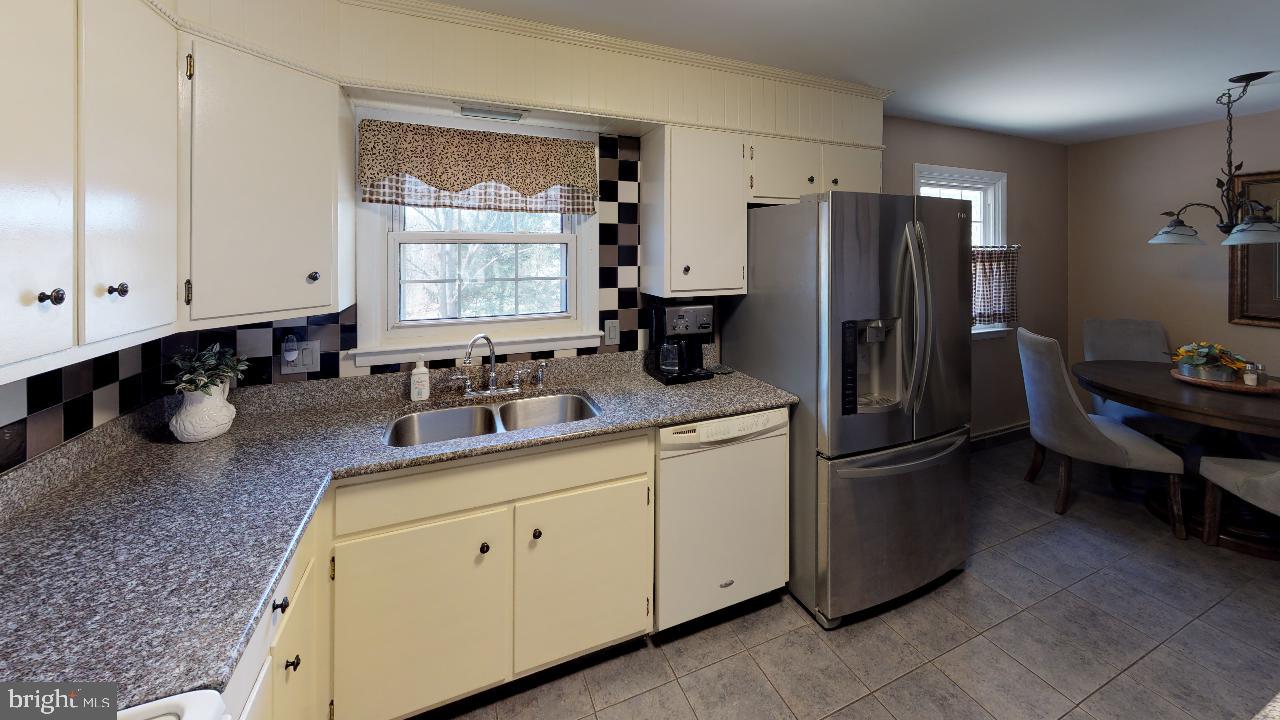 793 Mountain View Road Reading, PA 19607 - Photo 4 of 21 a kitchen with stainless steel appliances a refrigerator sink and cabinets