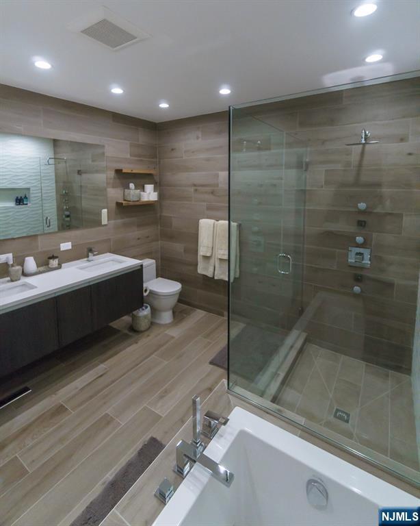 314 The Promenade Edgewater, NJ 07020 - Photo 21 of 37 a bathroom with a sink a toilet and shower