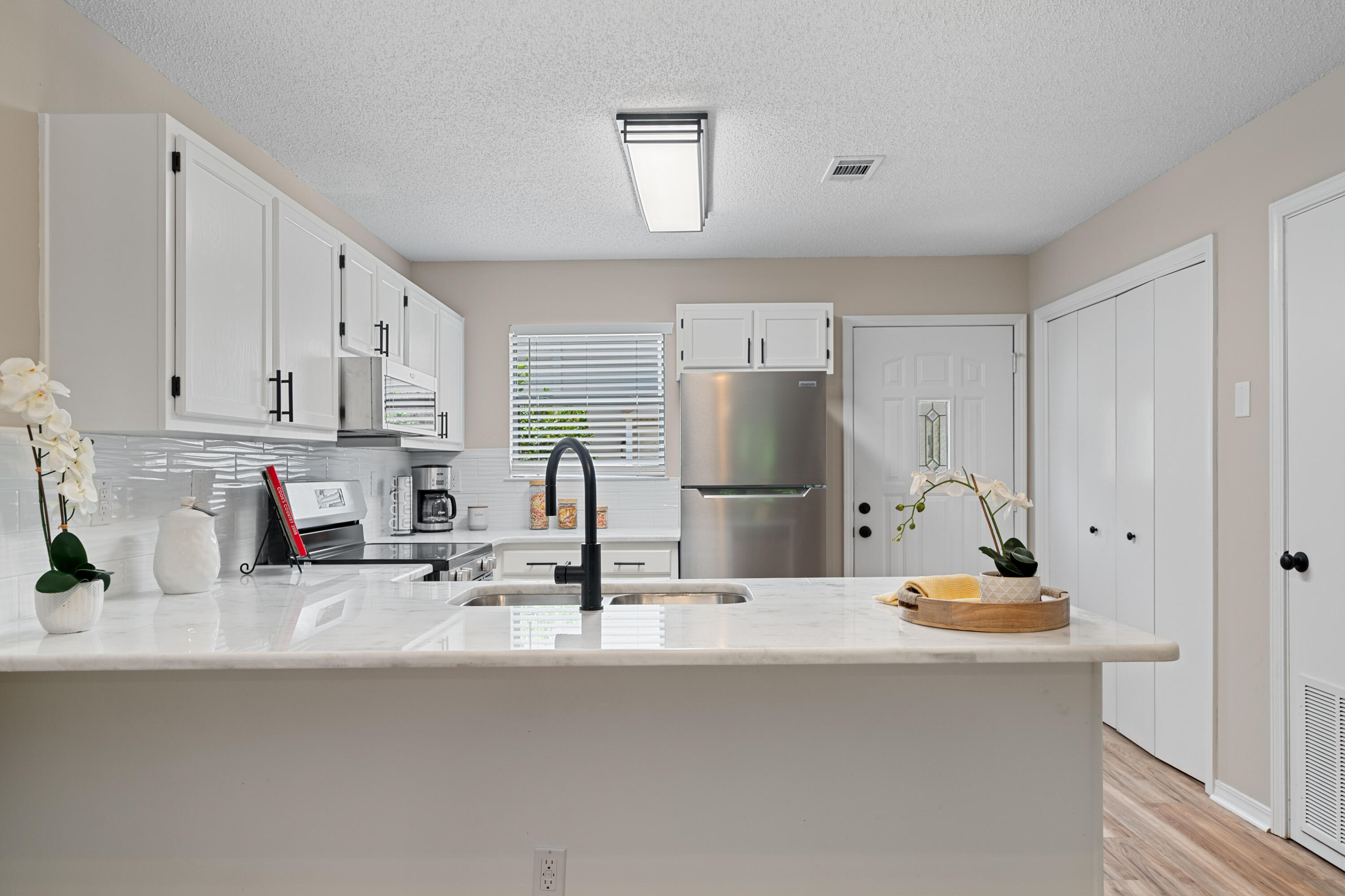1681 Highway 98, Unit 3 Mary Esther, FL 32569 - Photo 1 of 21 a kitchen with stainless steel appliances a sink and cabinets