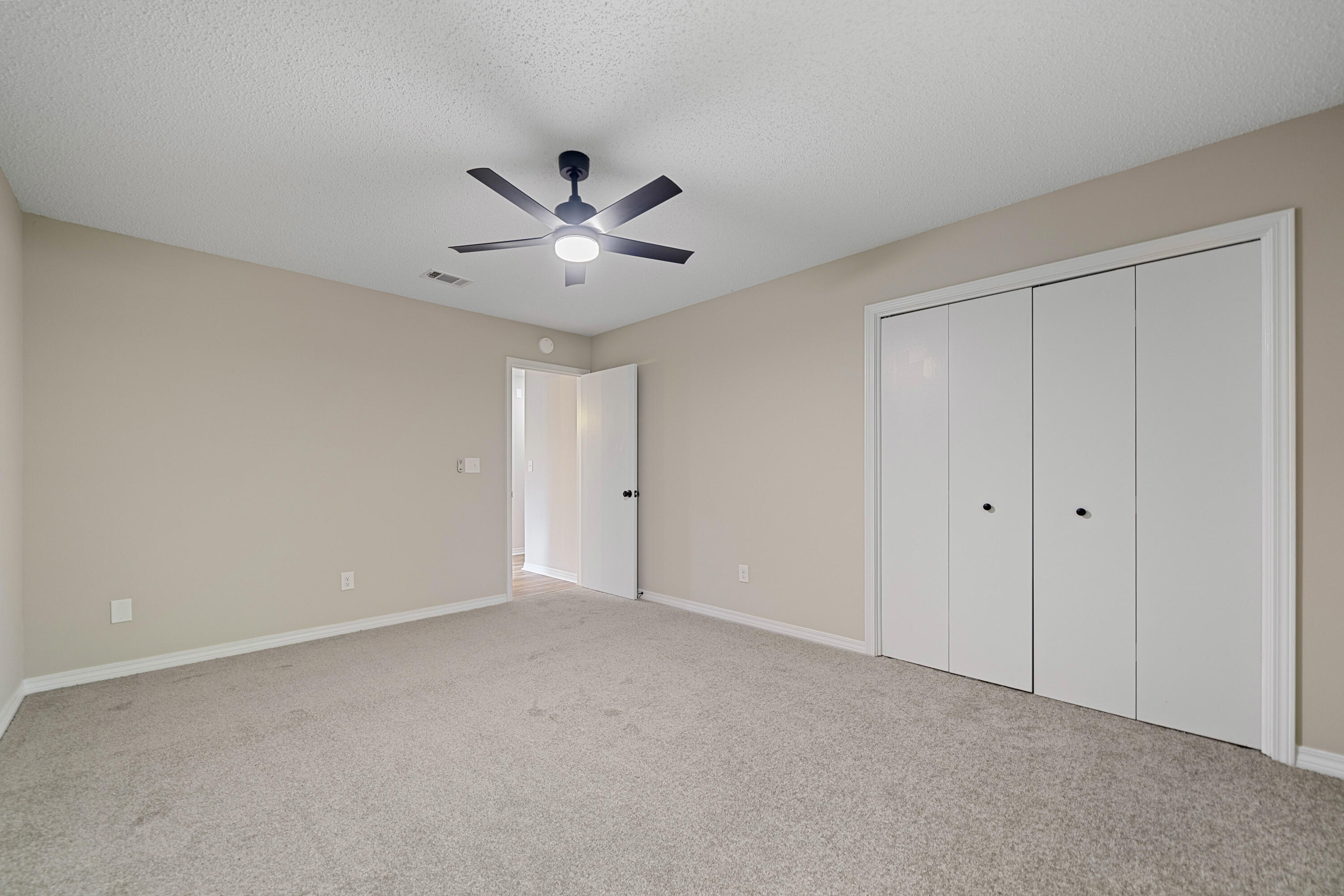 1681 Highway 98, Unit 3 Mary Esther, FL 32569 - Photo 13 of 21 a view of an empty room with a ceiling fan