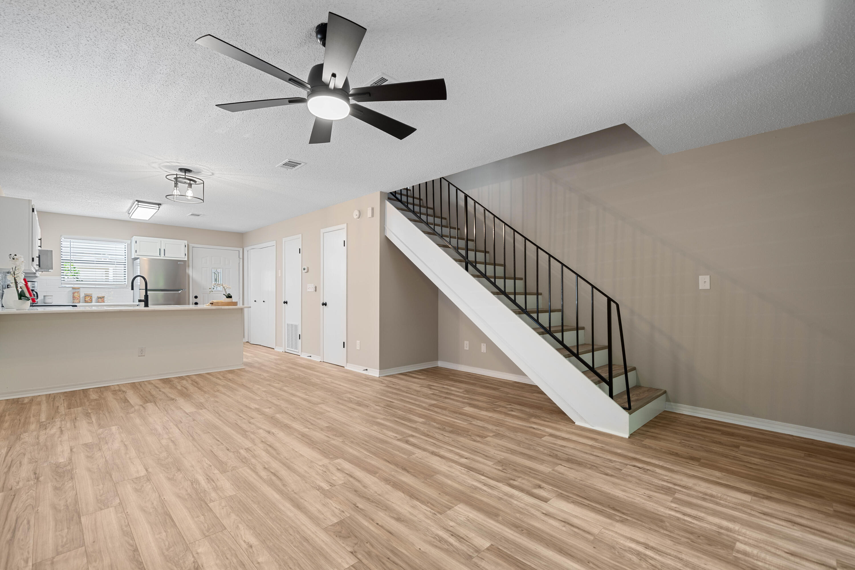 1681 Highway 98, Unit 3 Mary Esther, FL 32569 - Photo 17 of 21 a view of an empty room with wooden floor and a ceiling fan