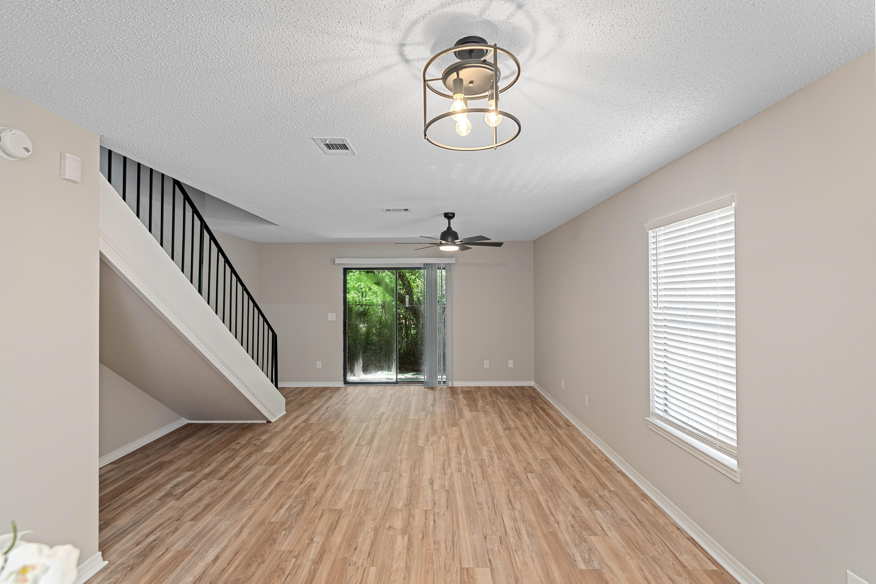 1681 Highway 98, Unit 3 Mary Esther, FL 32569 - Photo 19 of 21 a view of empty room with wooden floor and fan