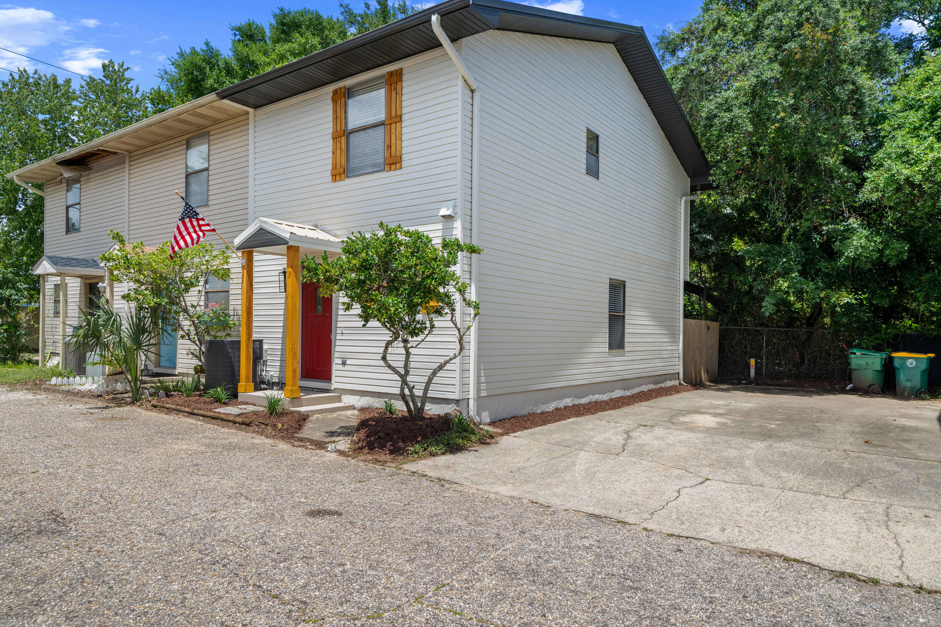 1681 Highway 98, Unit 3 Mary Esther, FL 32569 - Photo 20 of 21 a front view of house with yard and trees around