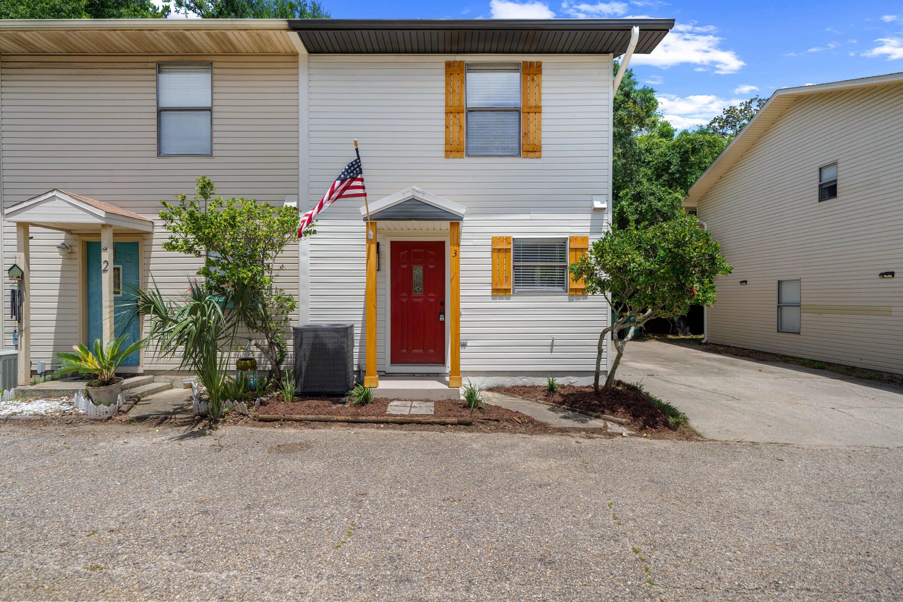 1681 Highway 98, Unit 3 Mary Esther, FL 32569 - Photo 2 of 21 a view of a house with a yard and garage