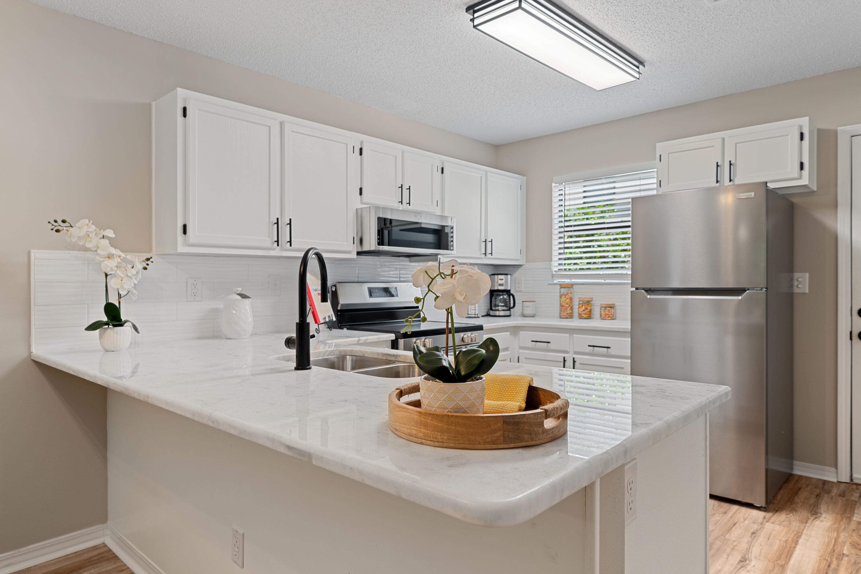 1681 Highway 98, Unit 3 Mary Esther, FL 32569 - Photo 4 of 21 a kitchen with a sink a refrigerator and a stove top oven
