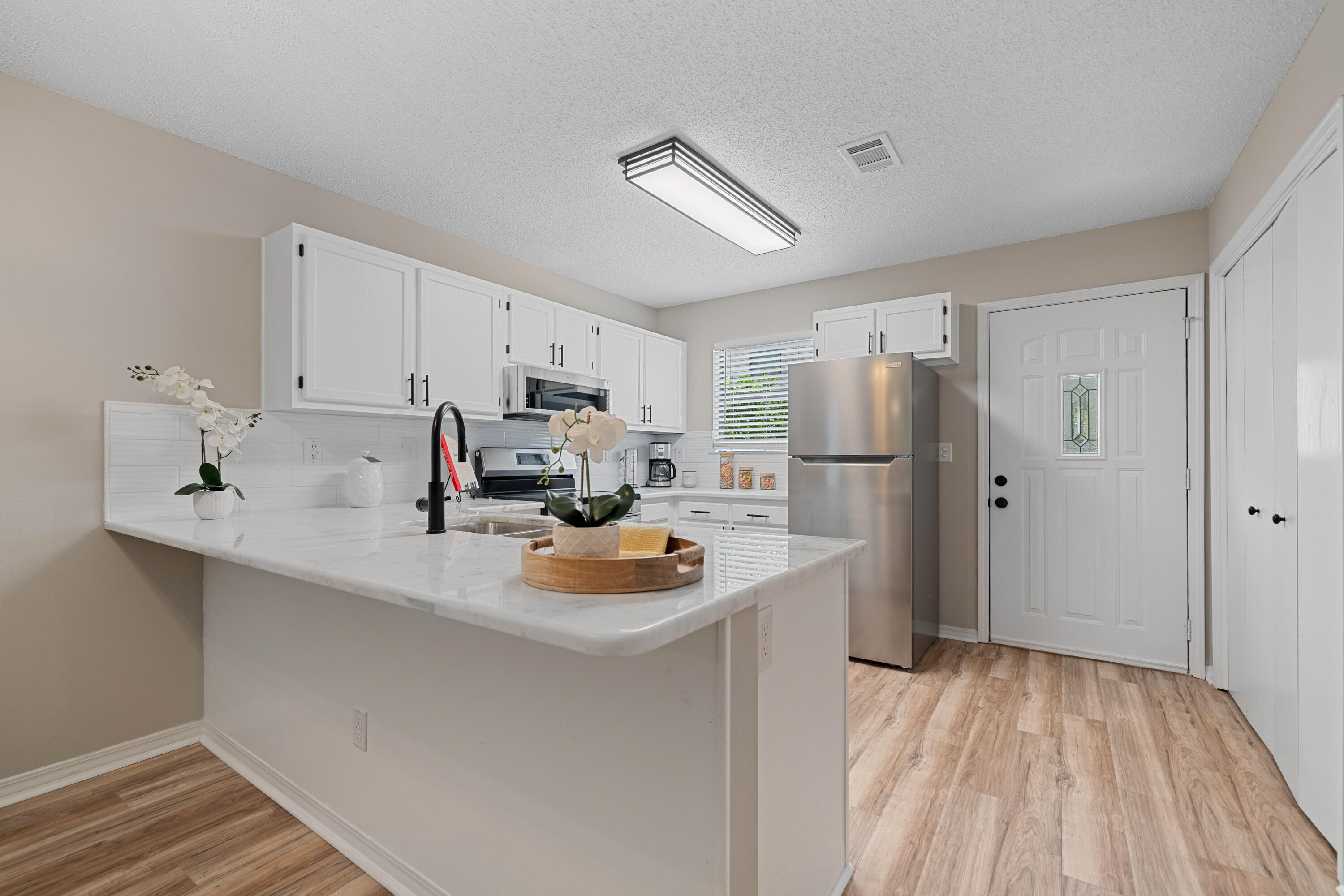 1681 Highway 98, Unit 3 Mary Esther, FL 32569 - Photo 5 of 21 a kitchen with refrigerator and window