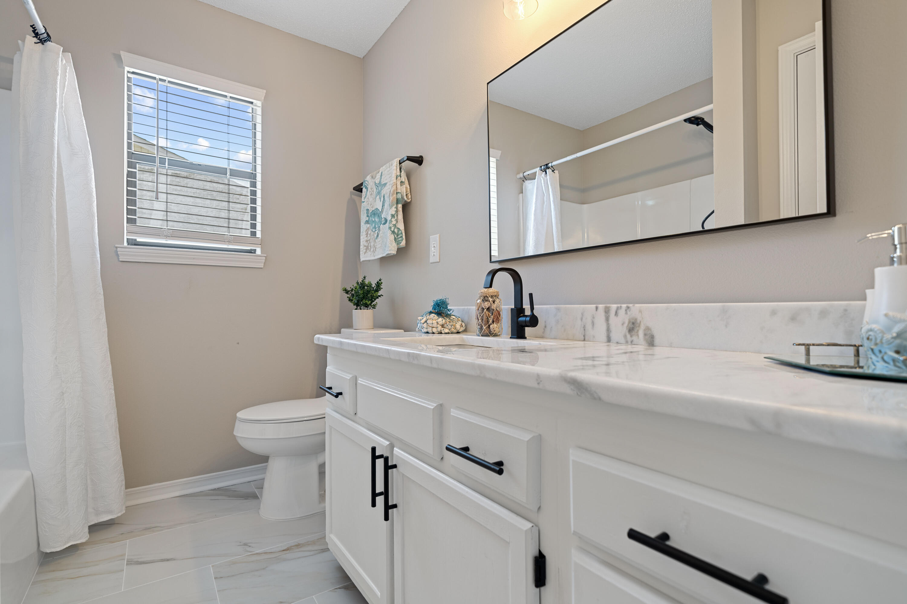 1681 Highway 98, Unit 3 Mary Esther, FL 32569 - Photo 8 of 21 a bathroom with a toilet sink and mirror