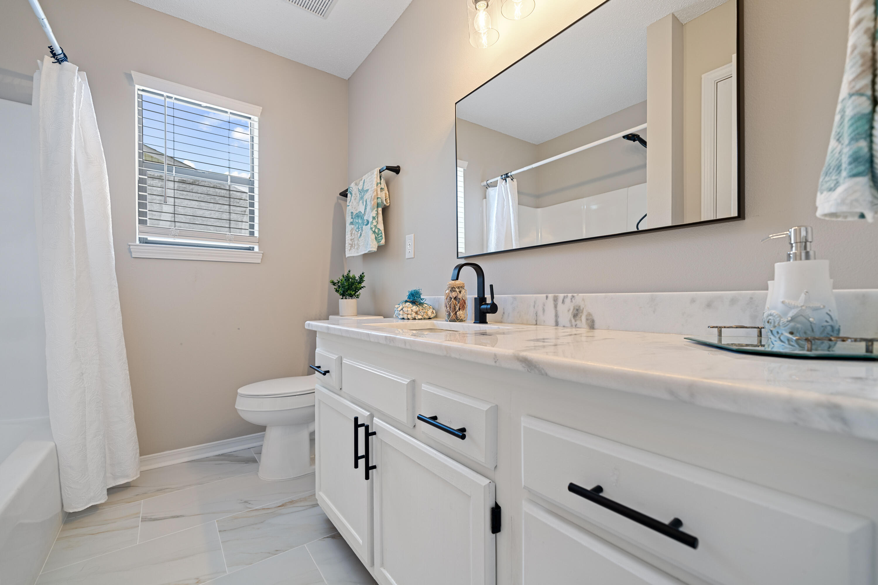 1681 Highway 98, Unit 3 Mary Esther, FL 32569 - Photo 9 of 21 a bathroom with a sink a toilet and mirror