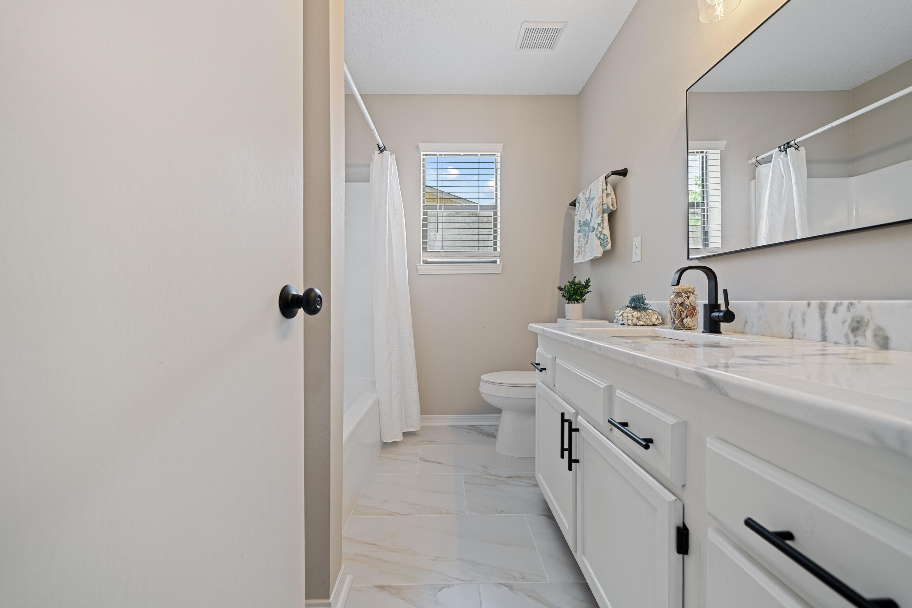 1681 Highway 98, Unit 3 Mary Esther, FL 32569 - Photo 10 of 21 a bathroom with a double vanity sink toilet and mirror