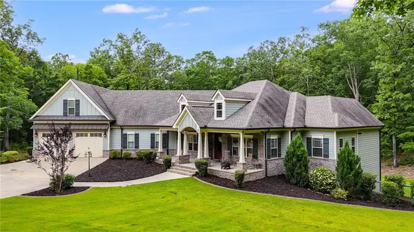 a front view of a house with yard and green space