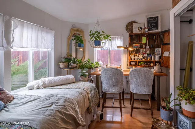 a bed sitting in a bedroom next to a window