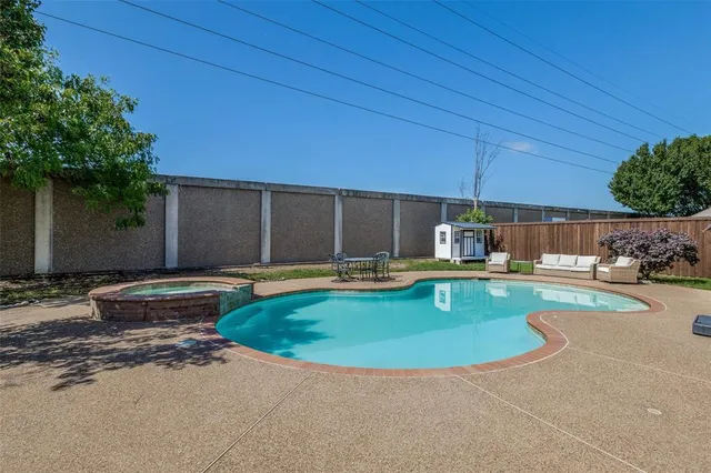 a view of a swimming pool with a patio