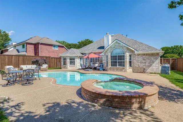 a front view of a house with swimming pool having outdoor seating