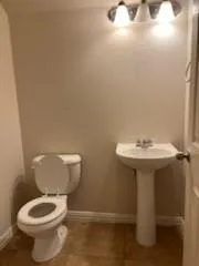 a white toilet sitting next to a bathroom sink
