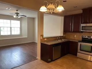 a kitchen with stainless steel appliances granite countertop a stove and a wooden cabinets