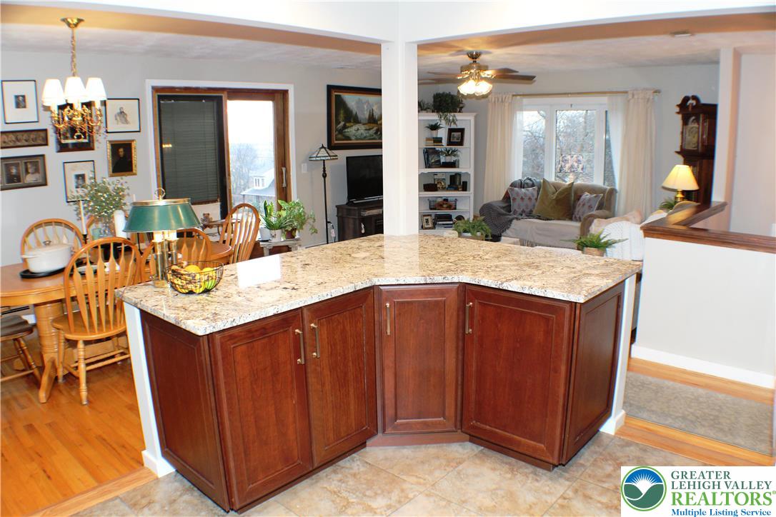 3604 Belfry Road Northampton, PA 18067 - Photo 16 of 44 a dining hall with stainless steel appliances granite countertop wooden cabinets a dining table and chairs
