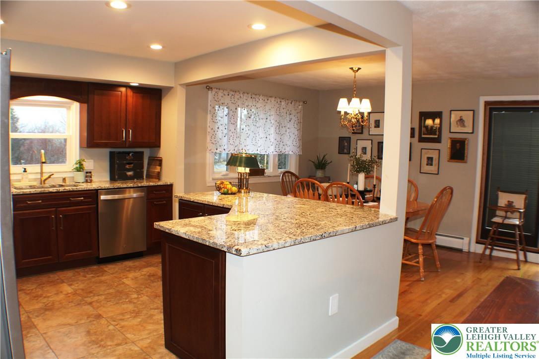3604 Belfry Road Northampton, PA 18067 - Photo 10 of 44 a kitchen with kitchen island granite countertop wooden cabinets a counter top space and stainless steel appliances