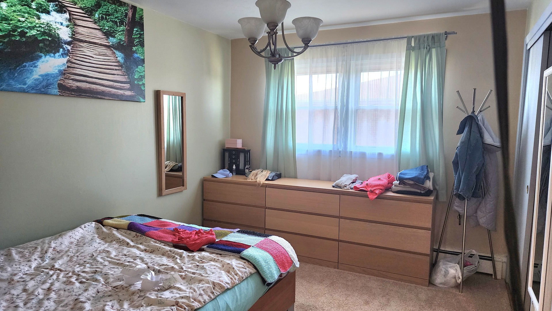 8125 South Roberts Road Bridgeview, IL 60455 - Photo 10 of 11 a bedroom with a bed and a chandelier