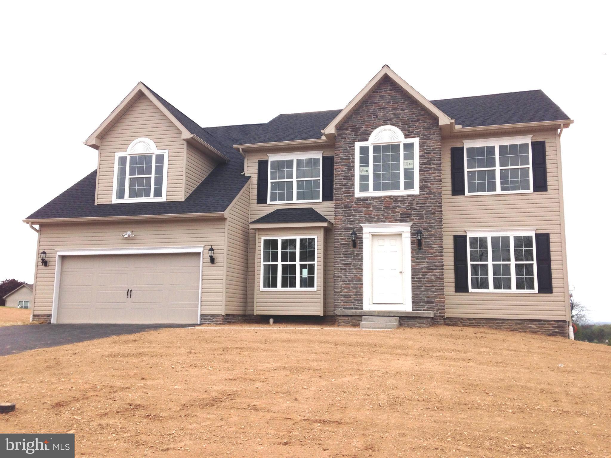 2695 Victorian Drive Dover, PA 17315 - Photo 2 of 5 a front view of a house with a yard and garage