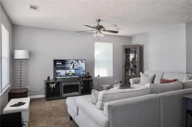 a living room with furniture and a fireplace