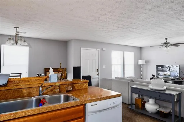 a kitchen with stainless steel appliances granite countertop a stove and a refrigerator