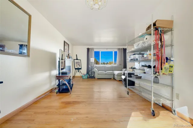 a view of a livingroom with workspace and a window