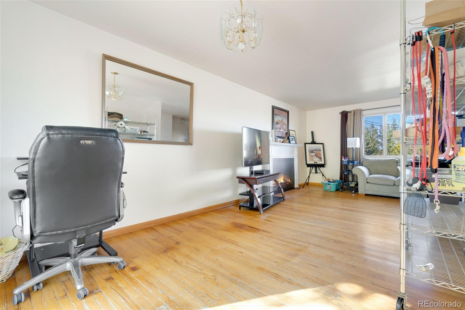 11760 West 32nd Avenue Wheat Ridge, CO 80215 - Photo 15 of 28 a bed room with a bed and a chair