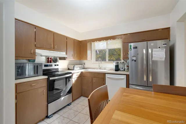 a kitchen with a sink stove and refrigerator
