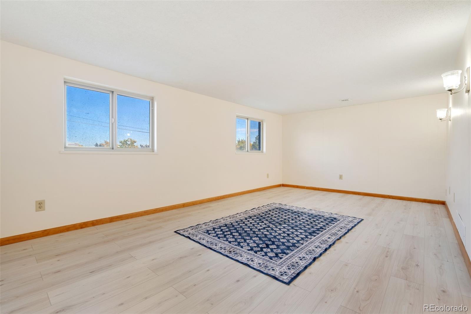 11760 West 32nd Avenue Wheat Ridge, CO 80215 - Photo 5 of 28 a view of an empty room with window and wooden floor