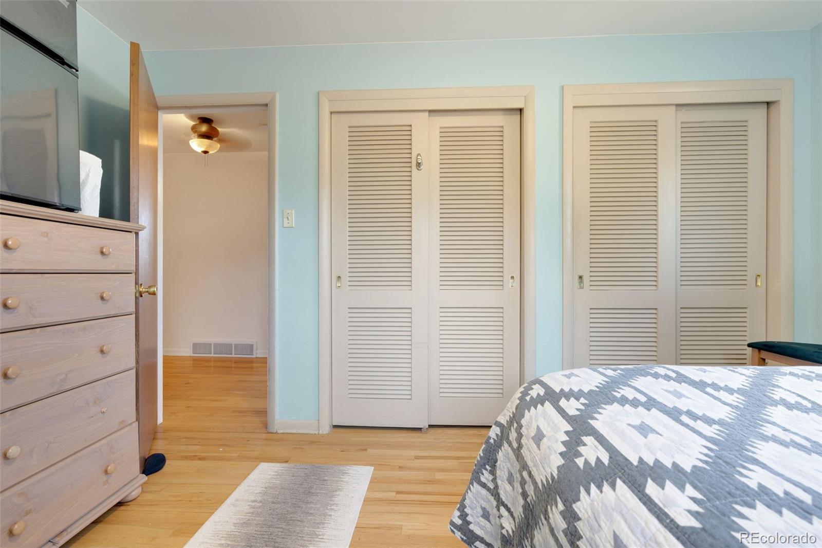 11760 West 32nd Avenue Wheat Ridge, CO 80215 - Photo 7 of 28 a bedroom with a bed and a mirror