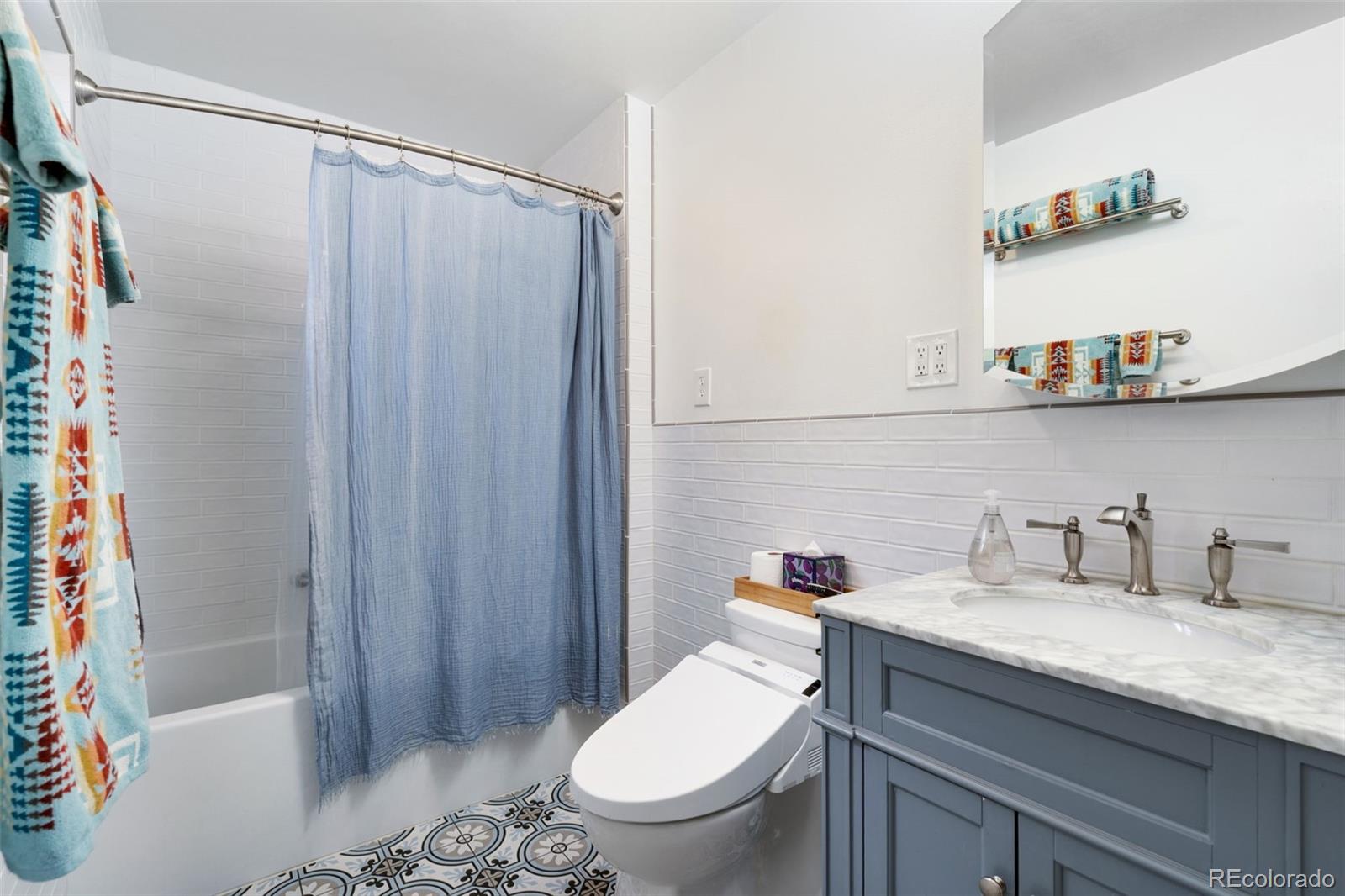 11760 West 32nd Avenue Wheat Ridge, CO 80215 - Photo 8 of 28 a bathroom with a granite countertop sink a toilet and shower
