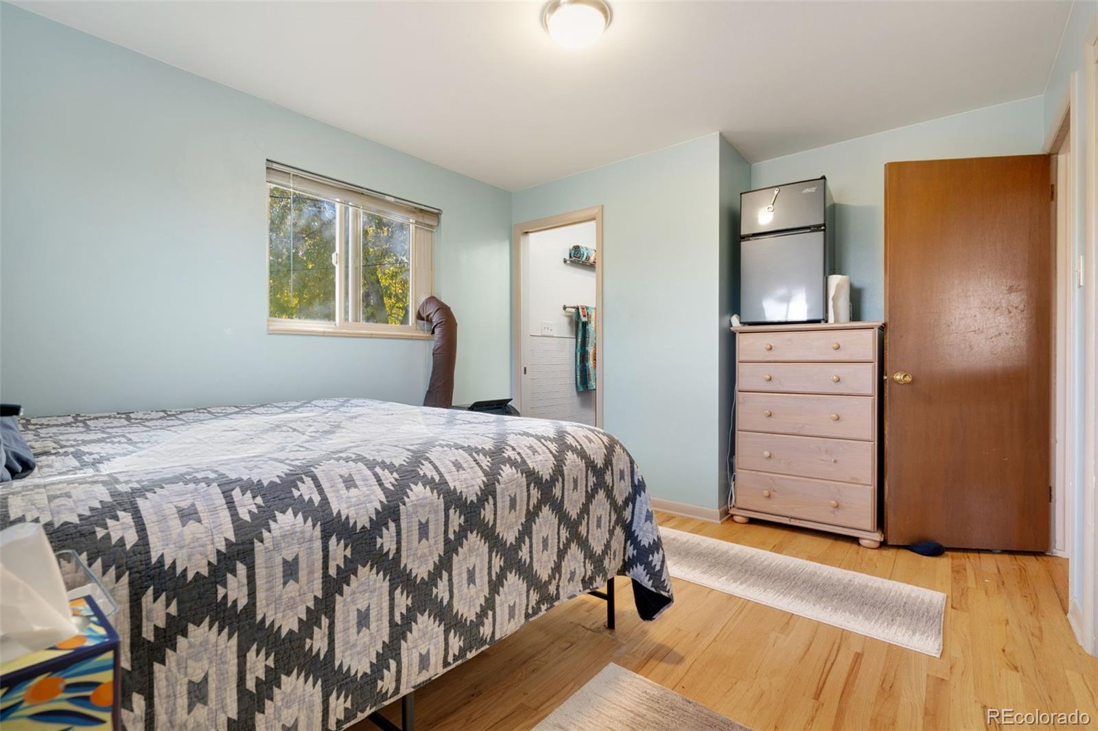 11760 West 32nd Avenue Wheat Ridge, CO 80215 - Photo 10 of 28 a bedroom with a bed and a dresser