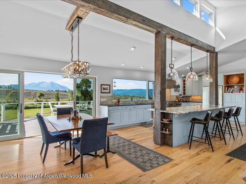 a dining room with furniture a chandelier and wooden floor