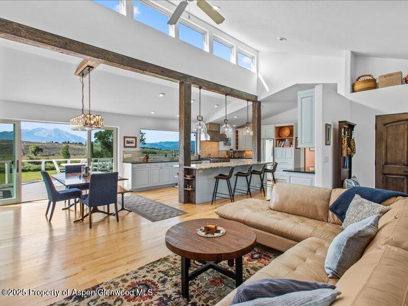 4100 County Road 103 Carbondale, CO 81623 - Photo 13 of 43 a living room with furniture and a dining table with wooden floor