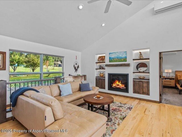 a living room with furniture fireplace and a table