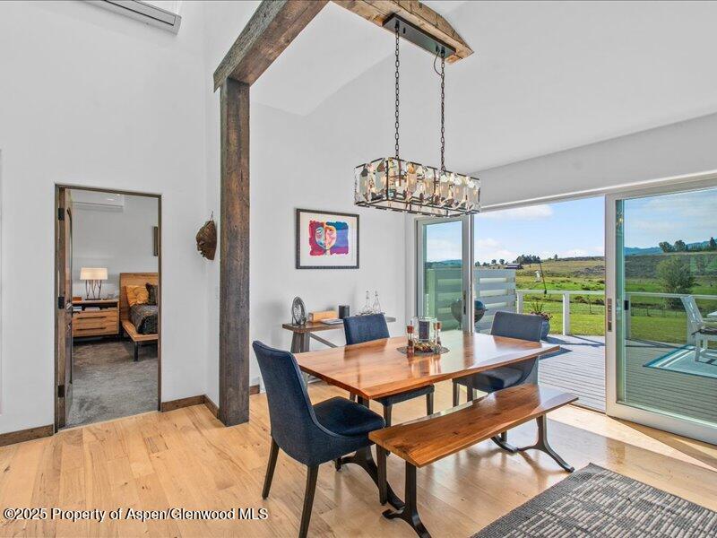 4100 County Road 103 Carbondale, CO 81623 - Photo 15 of 43 a dining room with furniture a chandelier and wooden floor