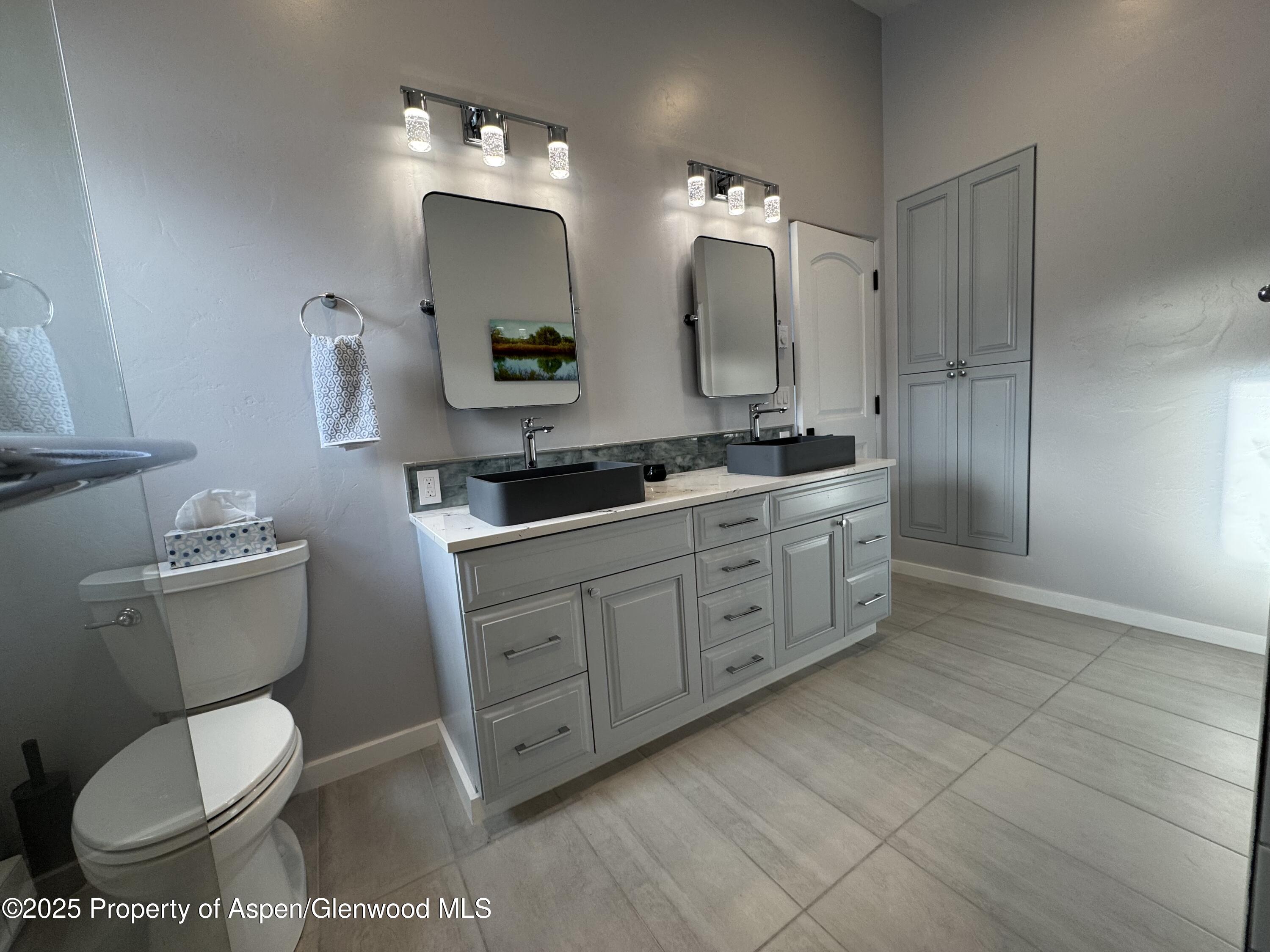 4100 County Road 103 Carbondale, CO 81623 - Photo 23 of 43 a bathroom with a toilet sink and mirror