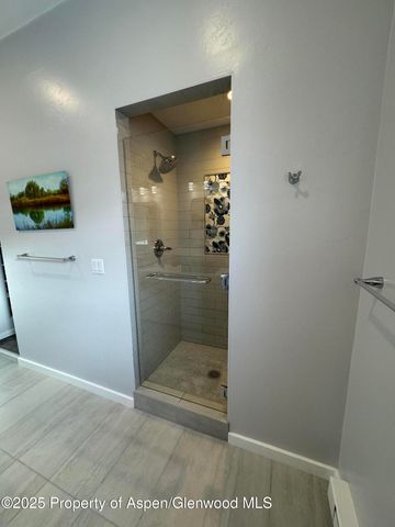 a bathroom with a glass door shower